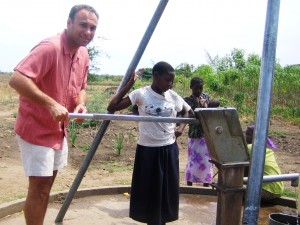 Me pumping water while visiting development projects in Zambia