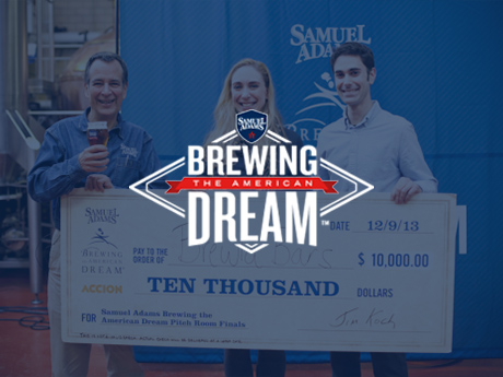 People holding large check with beer
