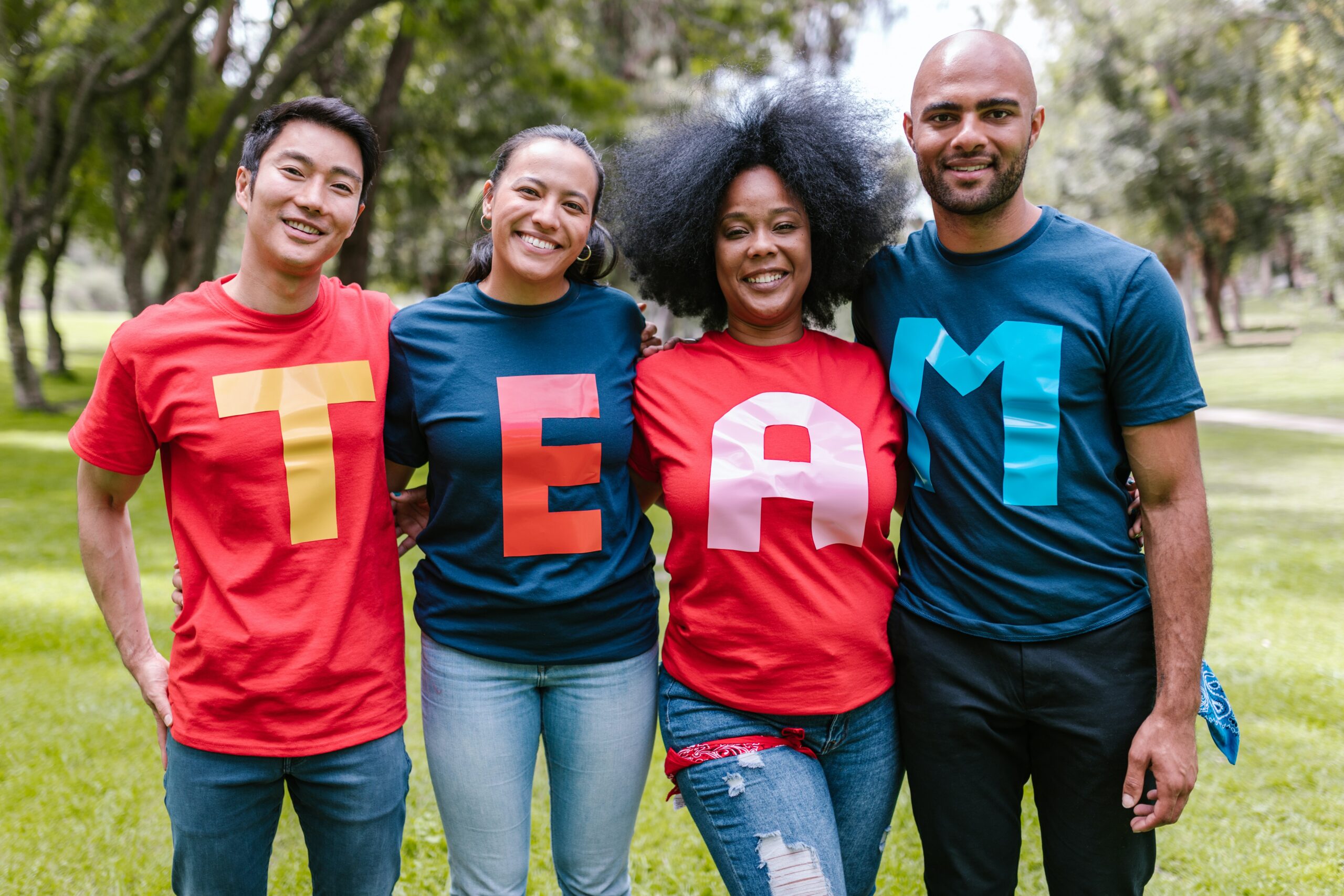 People posing for a photo with shirts spelling out "Team"