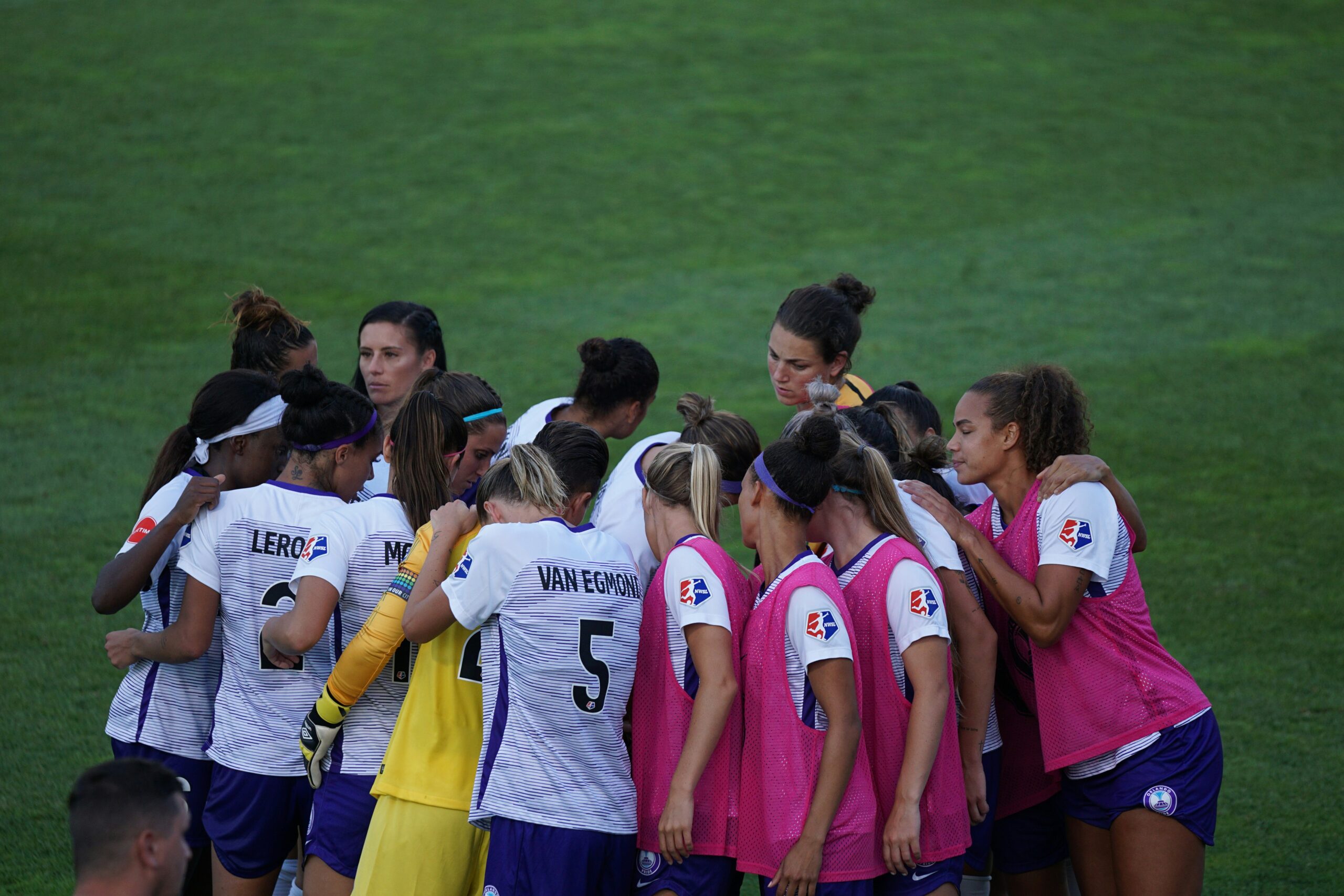 Soccer team huddled together on the field